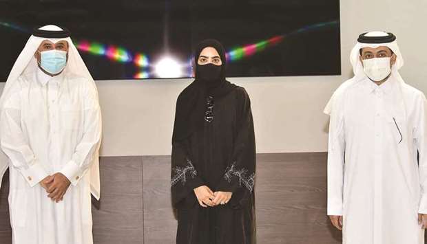 The QU president and dean of the College of Arts and Sciences honour student Noura al-Ansari.