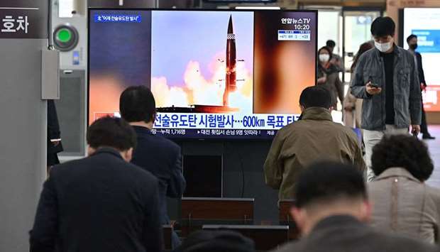 People watch a television screen at Suseo railway station in Seoul, showing news footage of North Korea's latest tactical guided projectile test.