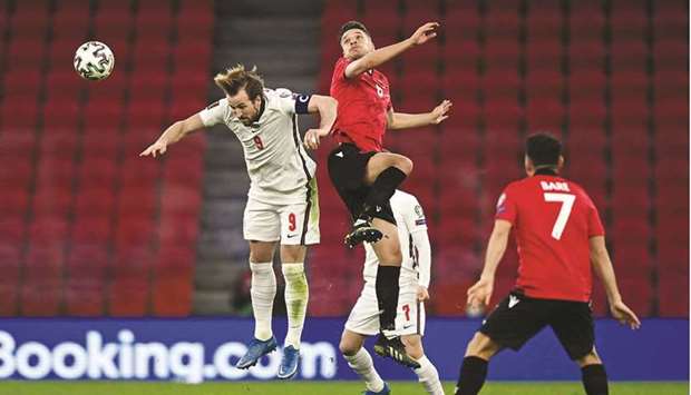 Englandu2019s forward Harry Kane (L) fights for the ball with Albaniau2019s defender Ardian Ismajli (C) during their FIFA World Cup Qatar 2022 qualification Group I match at the Arena Kombetare (Air Albania Stadium) in Tirana yesterday.