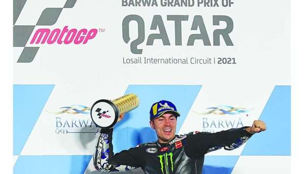 Monster Energy Yamaha MotoGP's Spanish rider Maverick Vinales celebrates after winning the Moto GP Qatar Grand Prix at the Losail International Circuit, in the city of Lusail.  KARIM JAAFAR / AFP