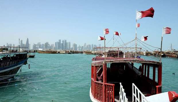 The national flags atop a boat at Doha Corniche flutter in the relentless wind. Different parts of Qatar, including Doha, witnessed windy conditions Sunday and blowing dust led to a drop in visibility in some areas. PICTURE: Thajudheen