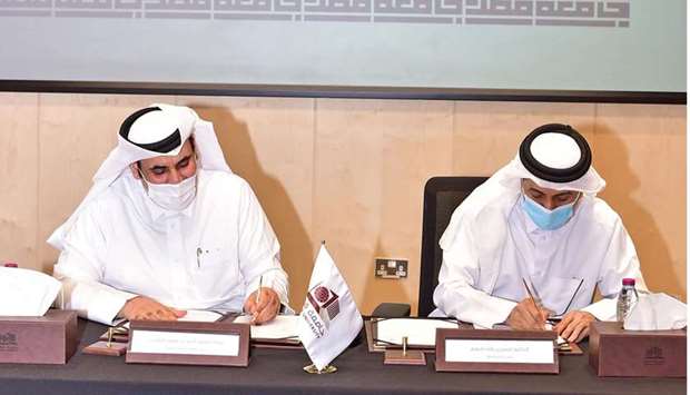 Dr. Hassan Al-Derham, President of QU and Ahmed bin Issa Al Mohannadi, Chairman of GTA, signing the MoU.