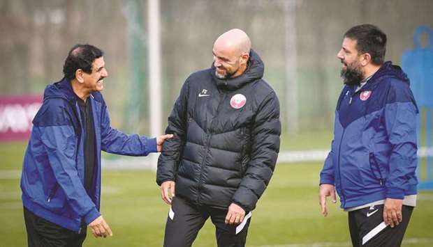 Qatar coach Felix Sanchez (centre) shares a light moment with support staff.