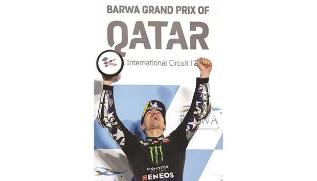 Monster Energy Yamaha MotoGP's Spanish rider Maverick Vinales celebrates after winning the Moto GP Qatar Grand Prix at the Losail International Circuit, in the city of Lusail on March 28, 2021.