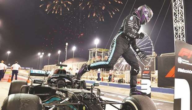 Mercedesu2019 British driver Lewis Hamilton celebrates after winning the Bahrain Formula One Grand Prix at the Bahrain International Circuit in the city of Sakhir on Sunday. At right, Max Verstappen.
