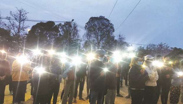 Protesters using mobile phone lights in a dawn demonstration against the military coup in Hakha township, western Myanmaru2019s Chin State.