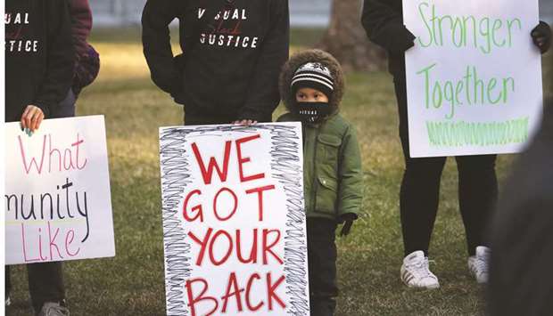 Activists gathered outside of the Hennepin County Government Center before the start of the trial of former ?Minneapolis police officer Derek Chauvin yesterday in Minneapolis, Minnesota. (AFP)