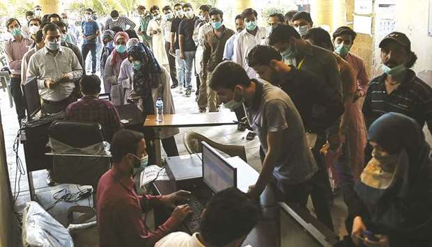 Health workers queue for the Chinese-made Sinopharm Covid-19 vaccine, at a vaccination centre in Karachi.