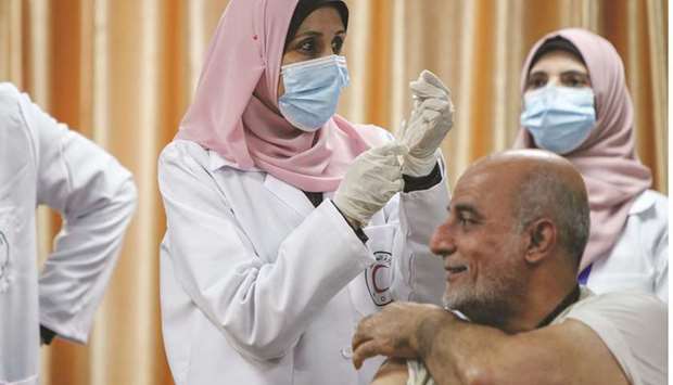 ROW: A health worker prepares to vaccinate former Palestinian health minister Jawad Tibi against the coronavirus disease (Covid-19) vaccine in Gaza City last month. (File photo).