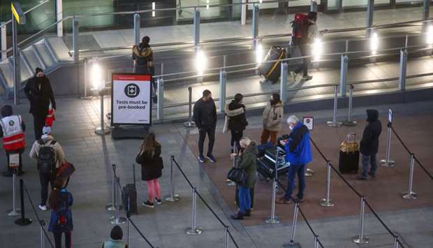 Travellers stand in line for Covid-19 tests after arriving at London Heathrow Airport. Even as vaccination initiatives gather pace, especially in worst affected countries such as the United States, South America, UK, Continental Europe and India, new Covid variants are leading governments to increase travel restrictions.
