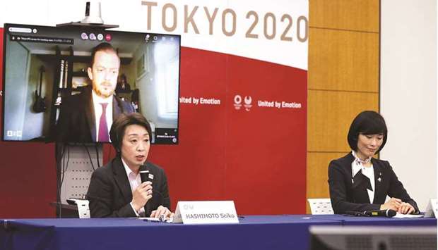 Seiko Hashimoto (L), president of Tokyo 2020, speaks as Tamayo Marukawa (R), Japanu2019s minister for the Tokyo Olympic and Paralympic Games, and Andrew Parsons (back L-on screen), president of the IPC, look on during the five-party meeting at the Tokyo 2020 headquarters in Tokyo yesterday.