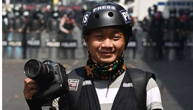 This picture taken on February 26 shows Associated Press photographer Thein Zaw posing for a photo during his coverage of demonstrations by protesters against the military coup in Yangon, a day before he was arrested.