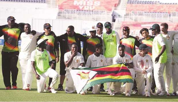 The victorious Zimbabwe team celebrate after winning first Test against Afghanistan in Abu Dhabi yesterday.