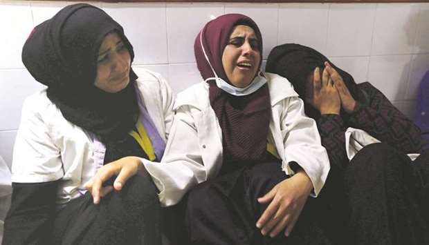 File photo shows colleagues of Palestinian nurse Razan al-Najar, who was killed during a protest at the Israel-Gaza border, react at a hospital in the southern Gaza Strip on June 1, 2018.