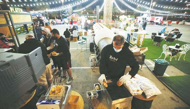 A vendor prepares burgers at Radical Barbecue, a food stand, at Al Aali Mall amid the coronavirus disease (Covid-19) pandemic, in Manama.