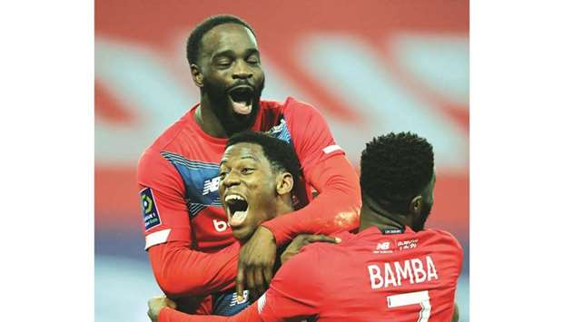 Lilleu2019s Jonathan David (C) celebrates with teammates after scoring against  Marseille on Wednesday night.