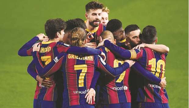 Barcelona players celebrate their third goal scored by Barcelonau2019s Danish forward Martin Braithwaite during the Spanish Copa del Rey (Kingu2019s Cup) semi-final second leg match against Sevilla FC at the Camp Nou stadium in Barcelona on March 3.