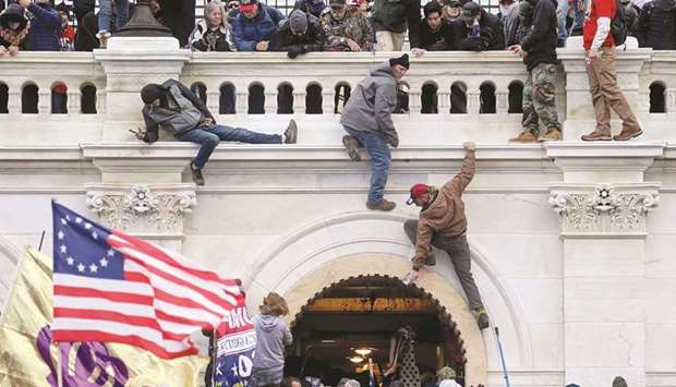 DAY THAT SHOOK THE CAPITOL: A mob of supporters of former US President Donald Trump fight with members of law enforcement at a door they broke open after storming the US Capitol Building in Washington on January 6 this year. (Reuters)