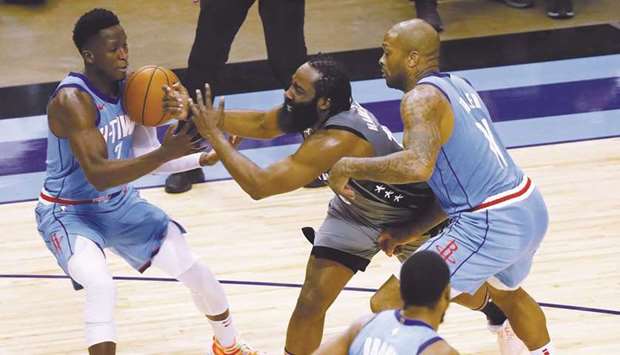 James Harden of the Brooklyn Nets loses the ball as he is pressured by PJ Tucker (left) of the Houston Rockets and Victor Oladipo during the second quarter at Toyota Center in Houston.  USA TODAY Sports