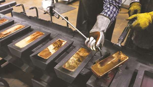 A worker uses a special tool to remove red hot gold ingots from their moulds in the foundry at the JSC Krastsvetmet non-ferrous metals plant in Krasnoyarsk, Russia. After enjoying its best year in a decade, the yellow metal has slumped more than 10% in 2021.