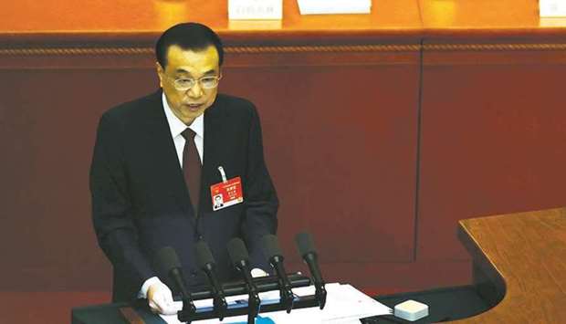 Chinese premier Li Keqiang speaks at the opening session of the National Peopleu2019s Congress (NPC) at the Great Hall of the People in Beijing yesterday. The growth target was set at above 6%, well below economistsu2019 forecasts, with the budget deficit expected to fall to 3.2% of gross domestic product, Li Keqiang said.