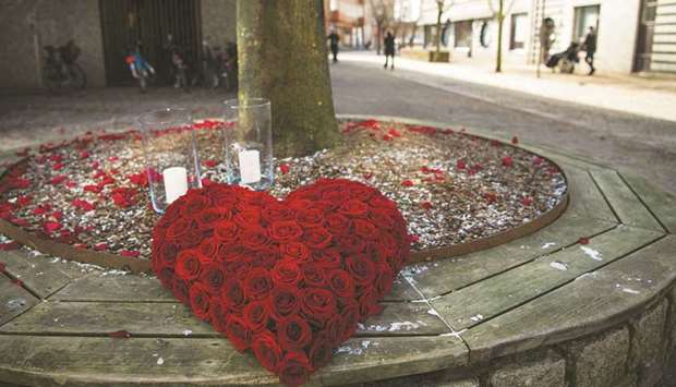 A heart-shaped bouquet of roses is seen in the main street of Vetlanda yesterday, a day after the stabbing attack.