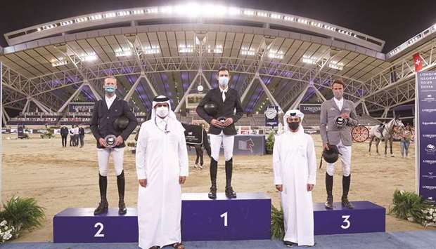Asian and Qatar Equestrian Federation president Hamad bin Abdulrahman al-Attiyah (second left) and LGCT Event Director and Commercial Manager at Al Shaqab Omar al-Mannai (second right) pose with the podium finishers of the CSI5* 1.55m class at the Longines Arena at Al Shaqab on Friday..