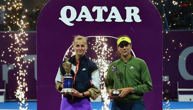 Qatar Total Open winner Petra Kvitova (left) of Czech Republic and runner-up Garbine Muguruza of Spain pose with their trophies after the final at Khalifa International Tennis and Squash Complex