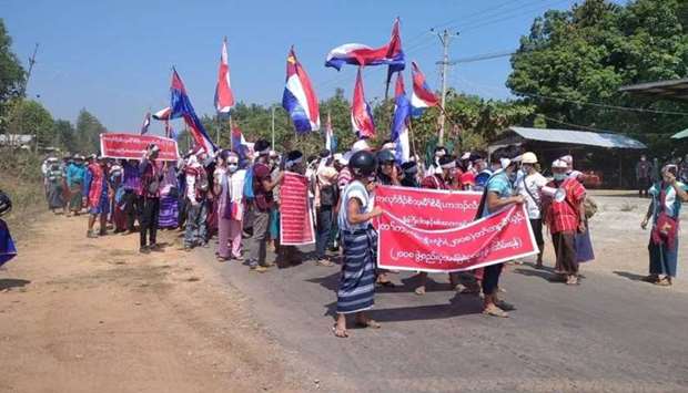 Protesters hold placards during the ant-coup protest in Hpapun Township, Kayin State, Myanmar