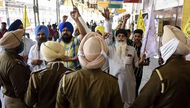 Punjab Police personnel stop farmers protesting against the central government's recent agricultural reforms during a Member of Parliament (MP) and Bharatiya Janata Party (BJP) senior leader Shwait Malik's visit to review the ongoing development projects at Amritsar railway station yesterday. AFP