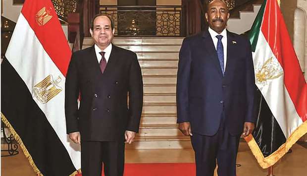A handout picture released by the Egyptian Presidencyu2019s official Facebook page yesterday shows President al-Sisi with Sudanu2019s General al-Burhan upon the formeru2019s arrival in Khartoum.