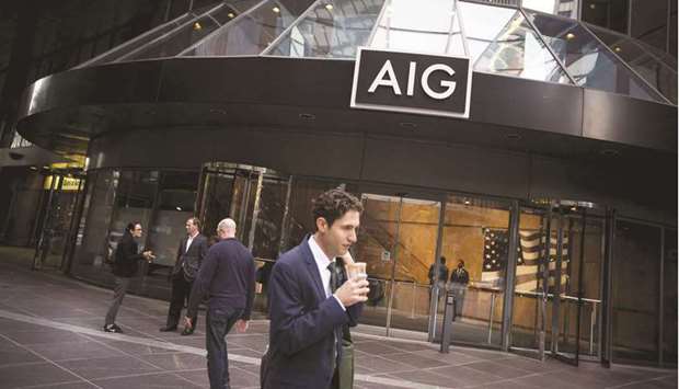 Pedestrians walk past the American International Group (AIG) headquarters in New York. The market for all types of Covid-19 travel coverage is estimated to be between $30bn to $40bn a year, according to travel insurance consultant Robyn Ingle, with companies like AXA and AIG underwriting protection.