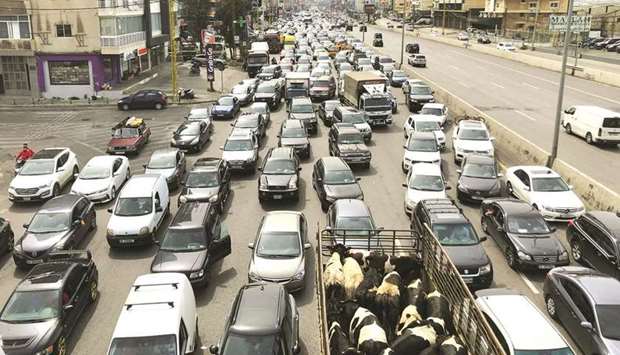 Vehicles are stuck in a traffic jam caused by demonstrators blocking a highway during a protest against the fall in Lebanese pound currency and mounting economic hardships, in Jal el-Dib, Lebanon, yesterday.