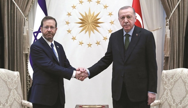 Turkish President Recep Tayyip Erdogan (right) shakes hands with Israelu2019s President Isaac Herzog during an official ceremony at the Presidential Complex in Ankara yesterday. (AFP)