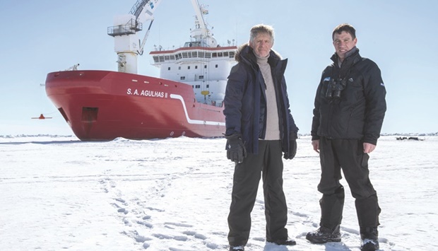 This handout picture taken in Antarcticau2019s Weddell sea on February 20, 2022, and released by the Falklands Maritime Heritage Trust shows Menson Bound, Director of Exploration of Endurance22 expedition (left) and John Shears, Expedition Leader, with SA Agulhas II in the background. (AFP)