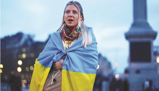 A demonstrator stands draped in a Ukrainian flag during a demonstration in support of Ukraine at Trafalgar Square in London on Wednesday. (Reuters)