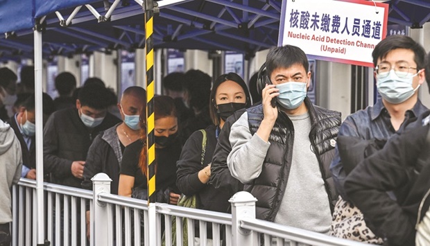 People queue up to be tested as a measure against the Covid-19 at the Shanghai Jinu2019an Central Hospital, in Shanghai yesterday.