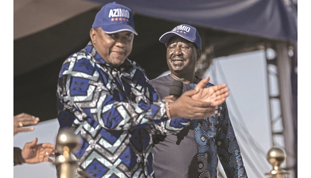 Kenyau2019s President, Uhuru Kenyatta (left) claps as he does a jig to a popular campaign jingle as he stands on a podium next to his former political nemesis, Raila Odinga whom he endorsed as a suitable presidential candidate for their coalition of political parties in Nairobi, yesterday.