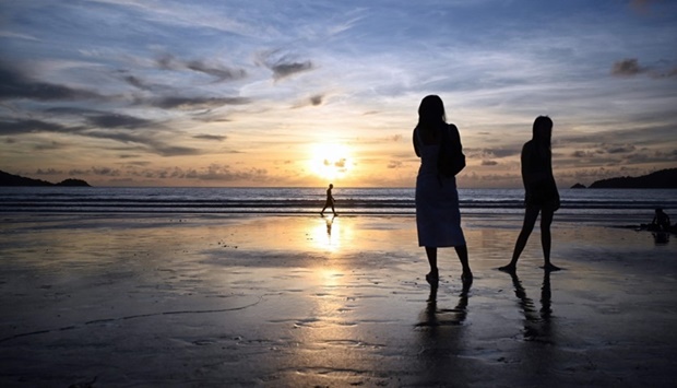 People walking along Patong Beach on the Thai island of Phuket. AFP file picture, June 29, 2021