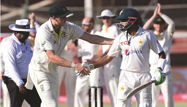Australiau2019s Cameron Green (left) shakes hands his Pakistanu2019s captain Babar Azam after the latteru2019s dismissal during the fifth and final day of the second Test in Karachi on Wednesday. (AFP)