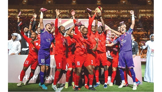 Al Duhail players celebrate with the trophy after winning the Amir Cup at the Khalifa International Stadium yesterday. Duhail won the prestigious title for the fourth time after they outplayed Al Gharafa 5-1 in the final. PICTURES: Noushad Thekkayil