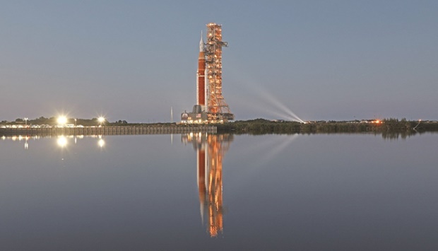 Nasau2019s massive Artemis I rocket (above) is illuminated at dusk atop a mobile launch platform en route to Launch Pad 39B from the Vehicle Assembly Building at the Kennedy Space Centre in Florida.