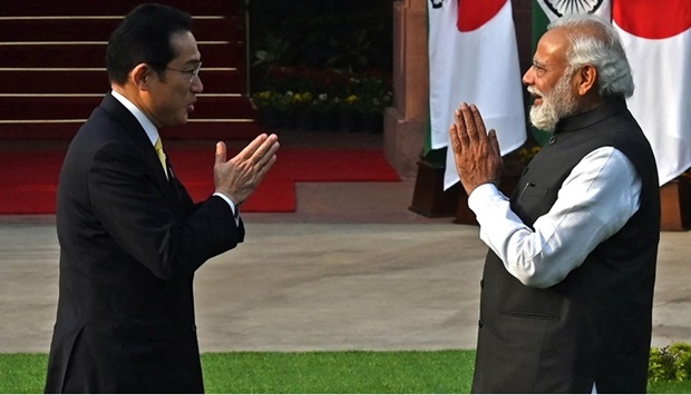 Japan's Prime Minister Fumio Kishida (L) and his Indian counterpart Narendra Modi gesture as they pose for pictures before their meeting at the lawns of the Hyderabad House in New Delhi on March 19, 2022.
