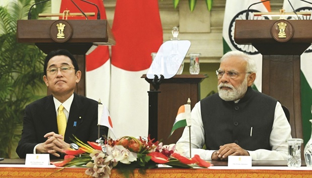 Indiau2019s Prime Minister Narendra Modi and Japanu2019s Prime Minister Fumio Kishida wait to sign an agreement after their meeting in New Delhi yesterday.