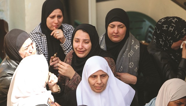 Women mourn a Palestinian killed by security forces during an arrest raid, during his funeral in Jenin in the northern West Bank, yesterday.