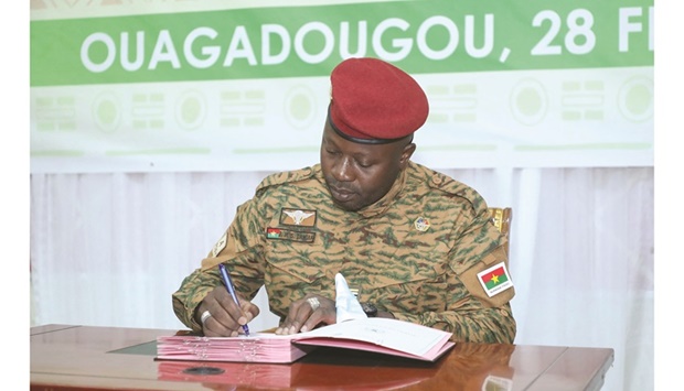 This handout picture released by the press office of Burkina Fasou2019s president shows the head of the junta Lieutenant Colonel Paul-Henri Damiba, signing a charter setting a three-year transition period before the country holds elections, in Ouagadougou, yesterday.