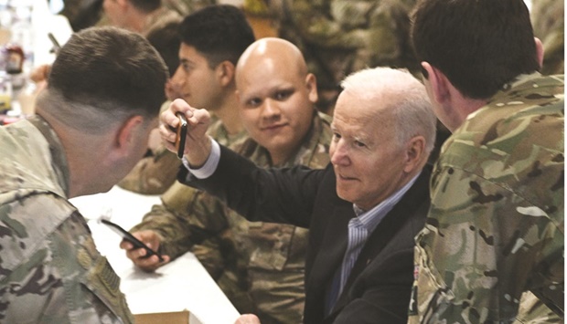 US President Joe Biden (centre) takes a selfie with service members from the 82nd Airborne Division, who are contributing alongside Polish allies to deterrence on the allianceu2019s eastern flank, in the city of Rzeszow in southeastern Poland, around 100kms from the border with Ukraine, yesterday.