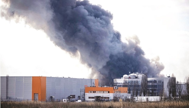 SPOTLIGHT: This photograph taken on March 24, 2022 shows smoke rising from a burning warehouse hit by a Russian shell in the suburbs of Kyiv. (AFP)