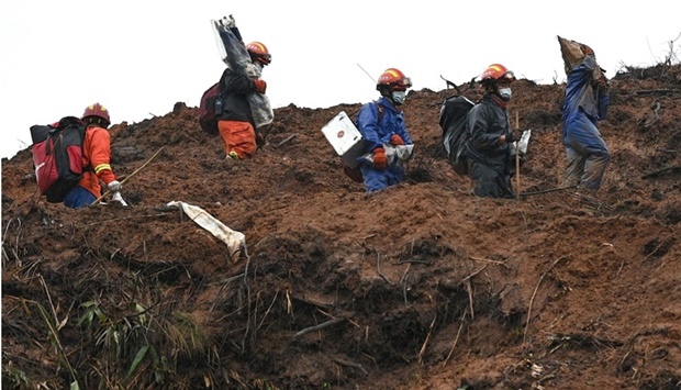 This file photo taken on March 24, 2022 shows rescue workers combing through the site of where China Eastern flight MU5375 crashed on March 21, near Wuzhou in southwestern Chinau2019s Guangxi province.