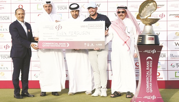 Commercial Banku2019s Board Member Sheikh Faisal bin Fahad bin Jassim al-Thani, Group Chief Executive Officer of Commercial Bank Joseph Abraham, Qatar Olympic Committee Second Vice President Dr Thani bin Abdulrahman al-Kuwari and Qatar Golf Association President Hassan bin Nasser al-Naimi pose with the Commercial Bank Qatar Masters winner Ewen Ferguson at the Doha Golf Club yesterday.